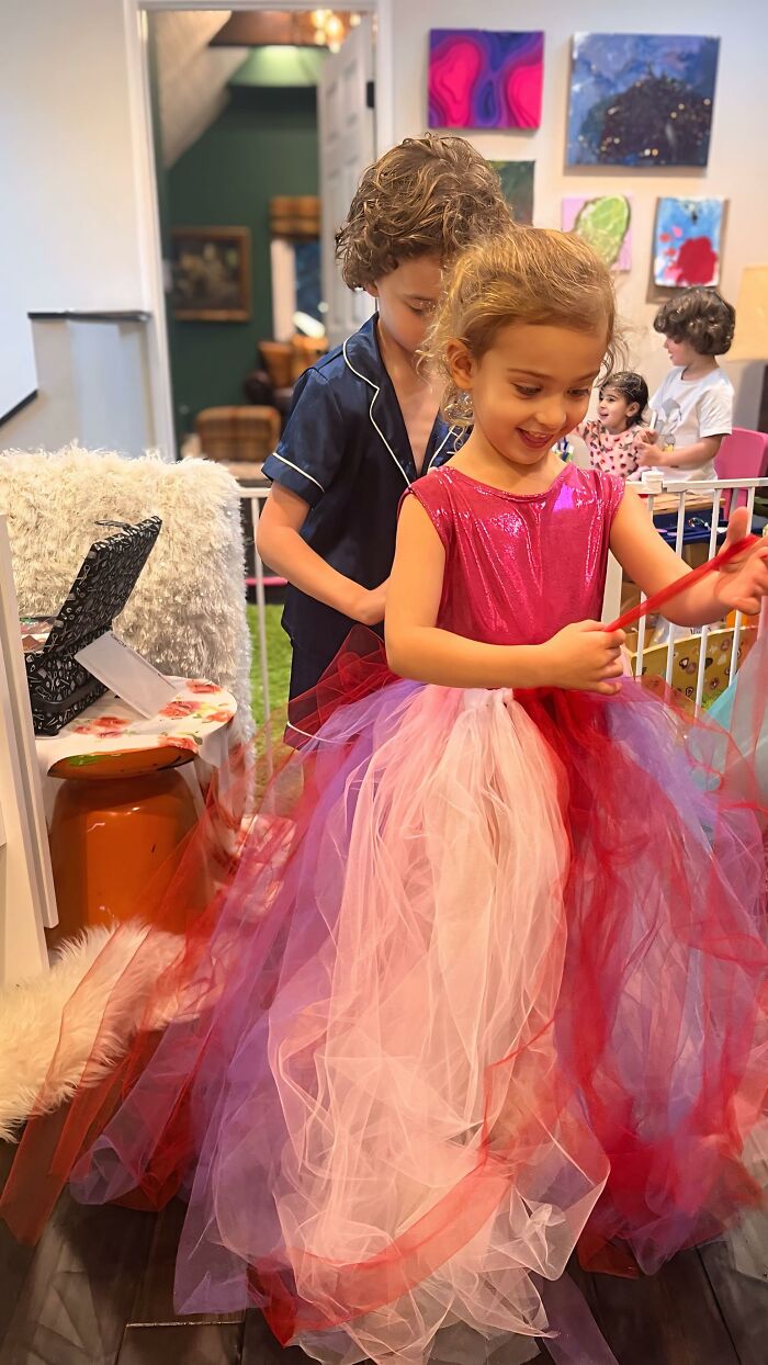 8-year-old fashion prodigy designing a colorful dress in a creative home setting.