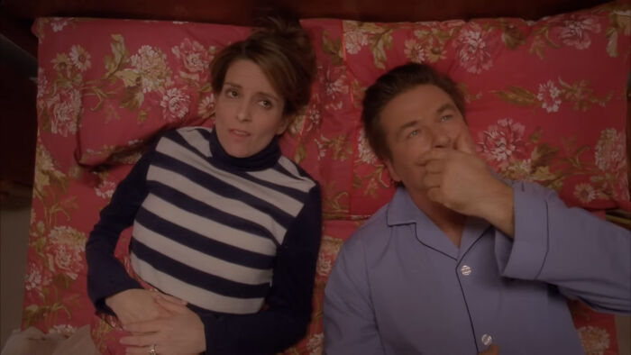 Two people lying on a floral bed, showcasing a scene from beloved shows watched repeatedly.