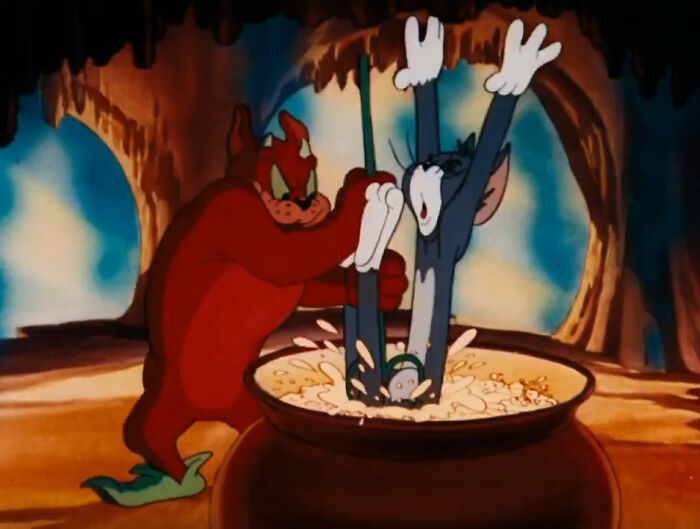 Animated cat in a cooking pot held by a devil character, illustrating a chaotic scene.