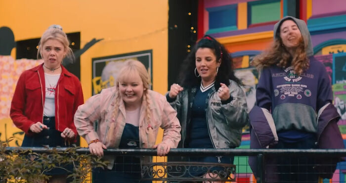 People enjoying a scene from a beloved show, featuring a colorful outdoor backdrop.