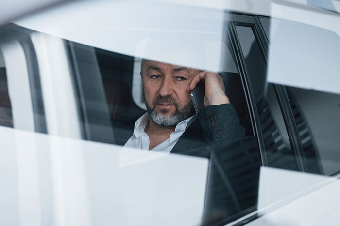 Man in a car looking thoughtful, depicting the experience of working as a bodyguard for the wealthy.