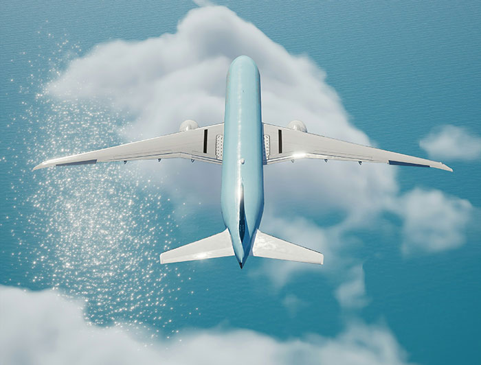 Airplane flying over clouds and ocean, seen from above, capturing travel and luxury.