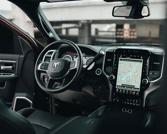 Luxurious car interior featuring a sleek dashboard and steering wheel.