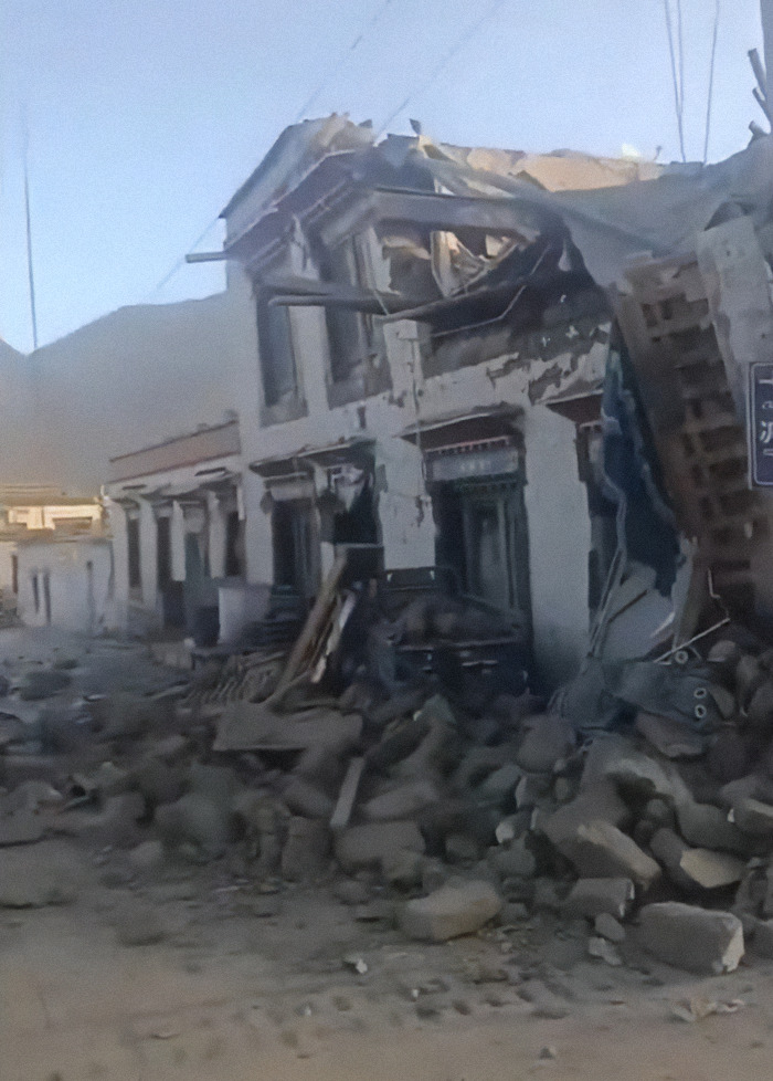 Rubble from a collapsed building after a 7.1 earthquake, highlighting disaster impact.