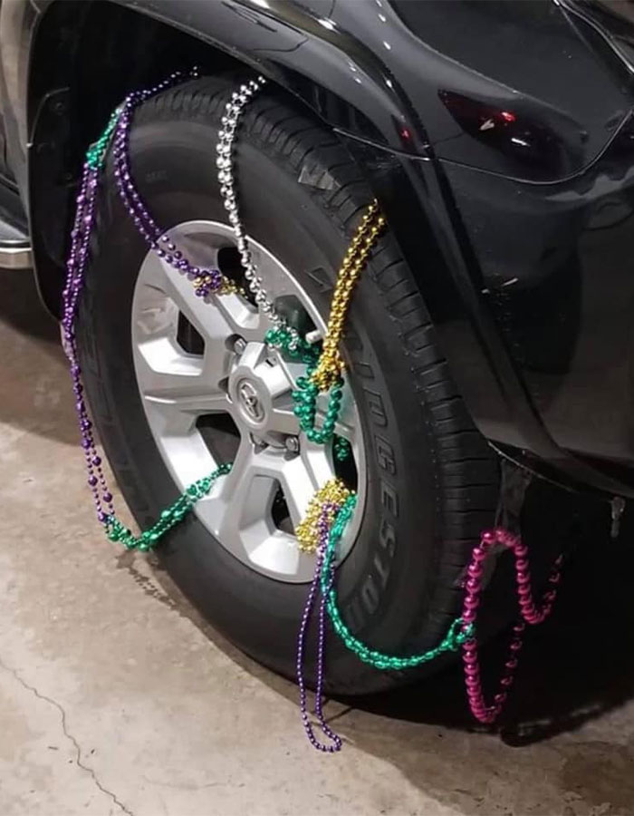 Car tire with colorful beads jokingly used as makeshift snow chains by Southerners in a snowstorm.