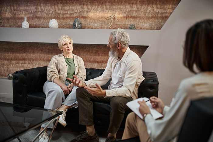 Couple in therapy session discussing challenges of neurodivergent relationship.