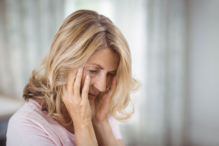 Woman looking distressed, highlighting the challenges with a neurodivergent husband.