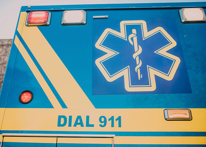 Ambulance with medical symbol and "Dial 911" text, representing American healthcare.