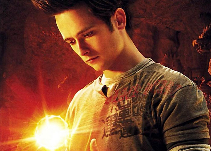 Actor holding a glowing orb in a dim setting, highlighting casting choices in Hollywood film history.