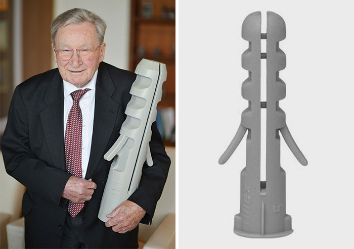 Elderly man in a suit holding a large wall plug model, highlighting random but fascinating facts.