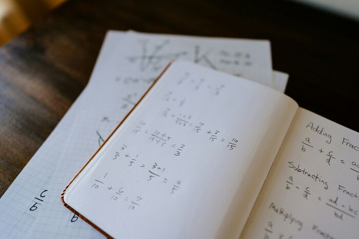 Notebook filled with complex math equations, illustrating displays of genius in human problem-solving.