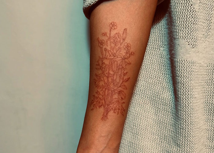 Floral tattoo on forearm, showcasing inked design.