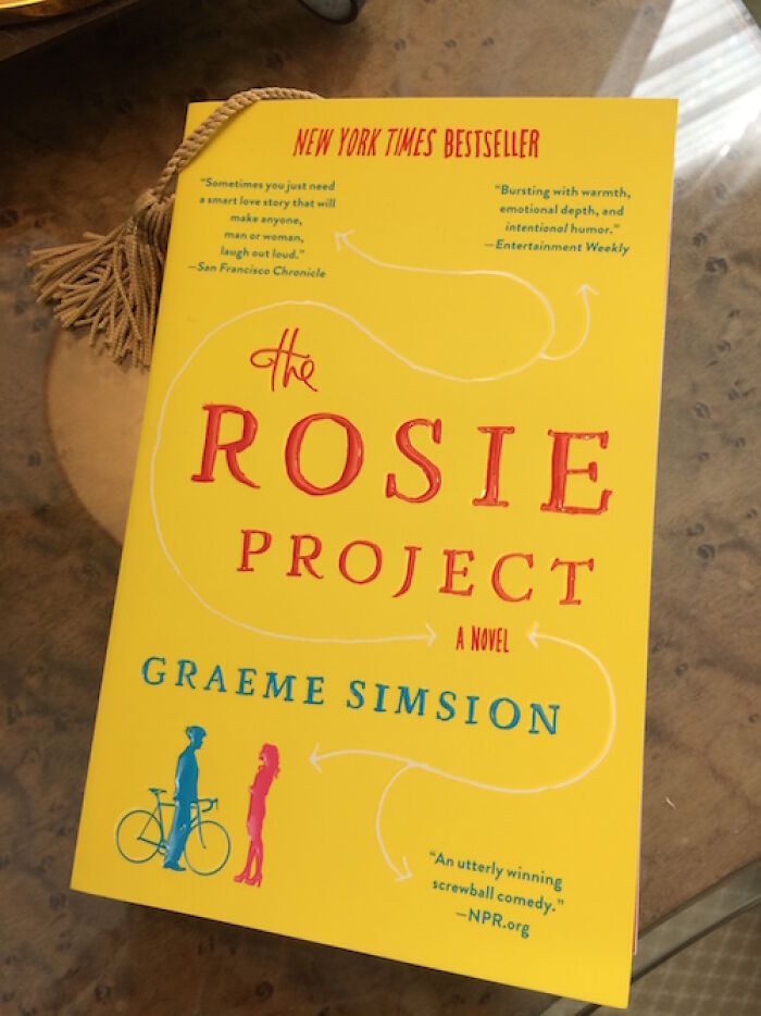 Cover of "The Rosie Project" novel, a romantic book with yellow background and red lettering.