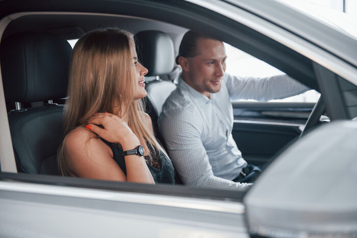 A couple on a first date sitting in a car, sharing a light conversation.