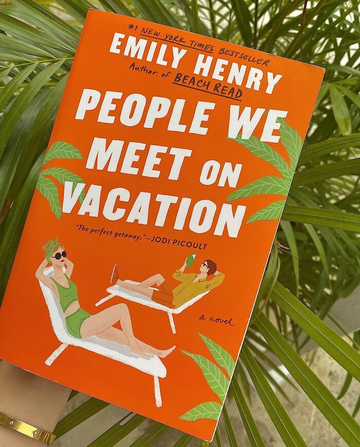 Romantic book "People We Meet on Vacation" by Emily Henry against palm leaves background.