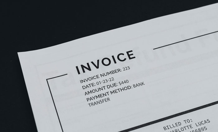 Invoice close-up showing details and payment method.