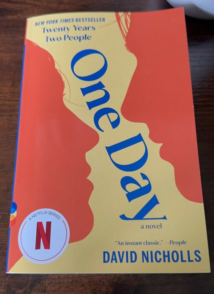 Cover of the romantic book "One Day" by David Nicholls, featuring silhouettes and Netflix branding.