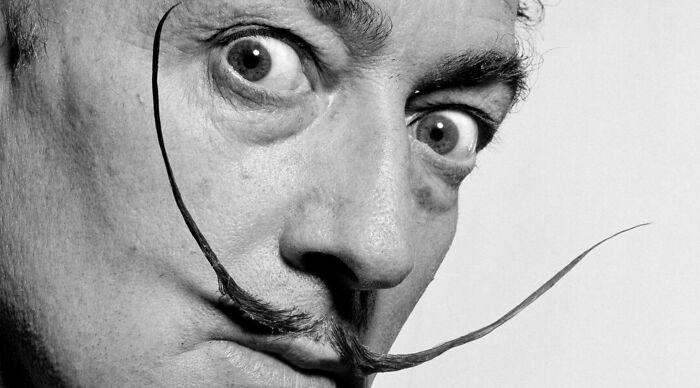 A person with an iconic mustache, captured in a black and white close-up, exemplifying art general knowledge.