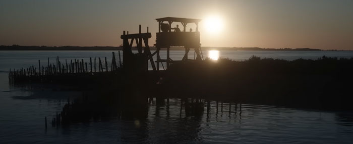 Silhouette of a lookout tower against sunset, related to the 28 Years Later cast setting.