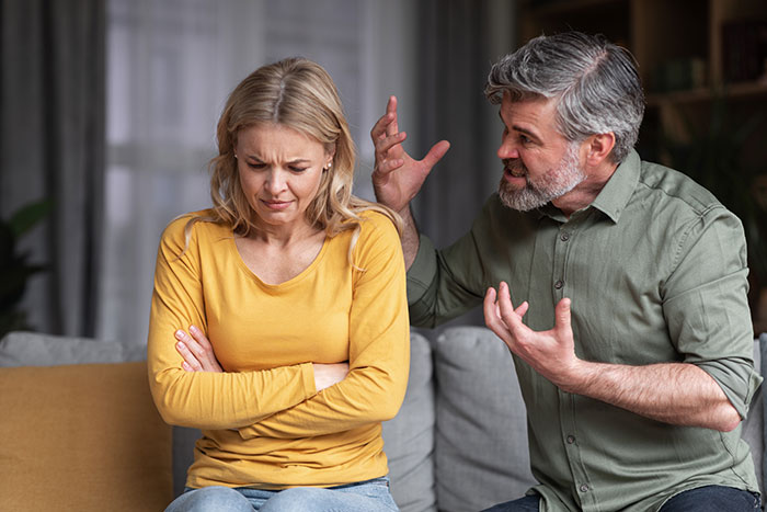 Woman looking upset while a man gestures, highlighting family inheritance conflict.