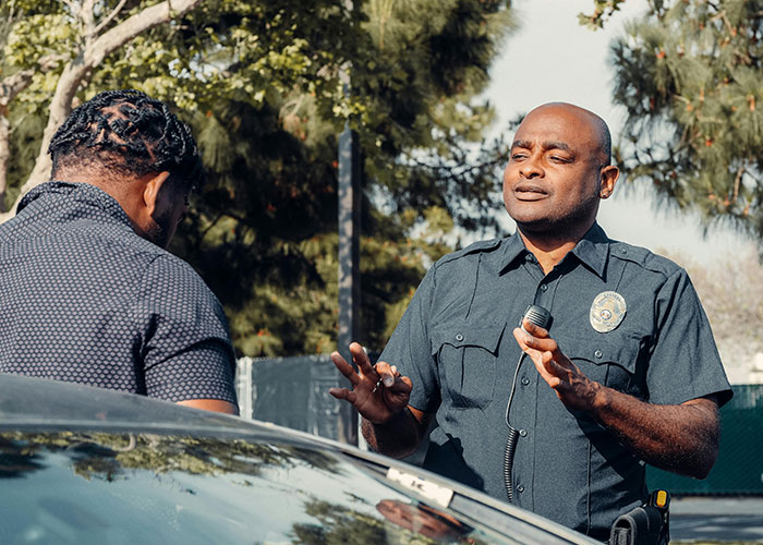 Police officer speaking to a driver in a driveway dispute involving a mom with dementia.