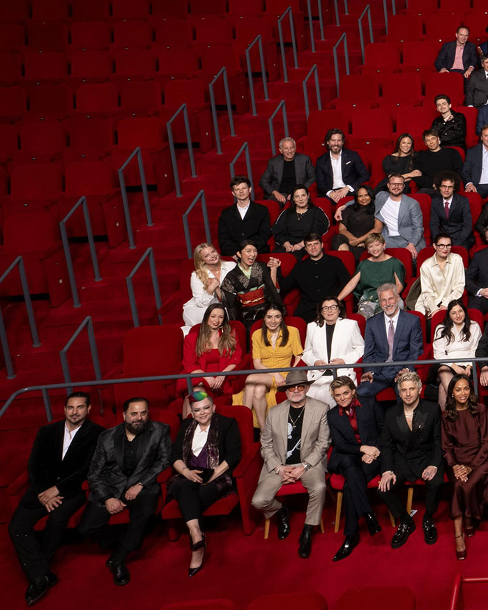 2025 Oscars nominees group in theater seating, sparking diversity outrage.