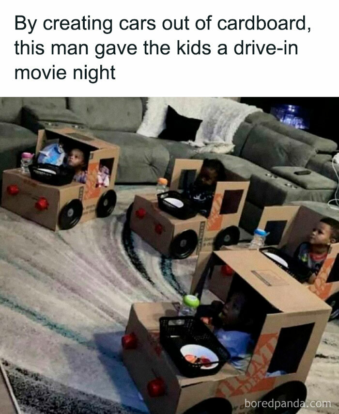 Children enjoy a drive-in movie night in cardboard cars, creating a heartwarming scene.