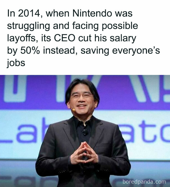 CEO in a suit smiling, cut salary to save jobs, creating a heartwarming moment.