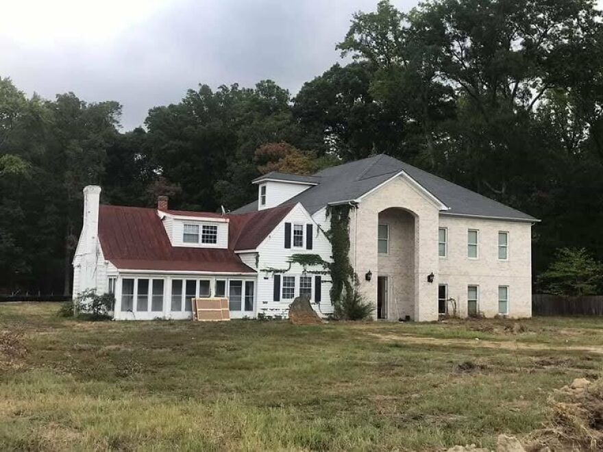 Mismatched architectural styles in a house with contrasting roofs and facades, exemplifying architecture shaming.