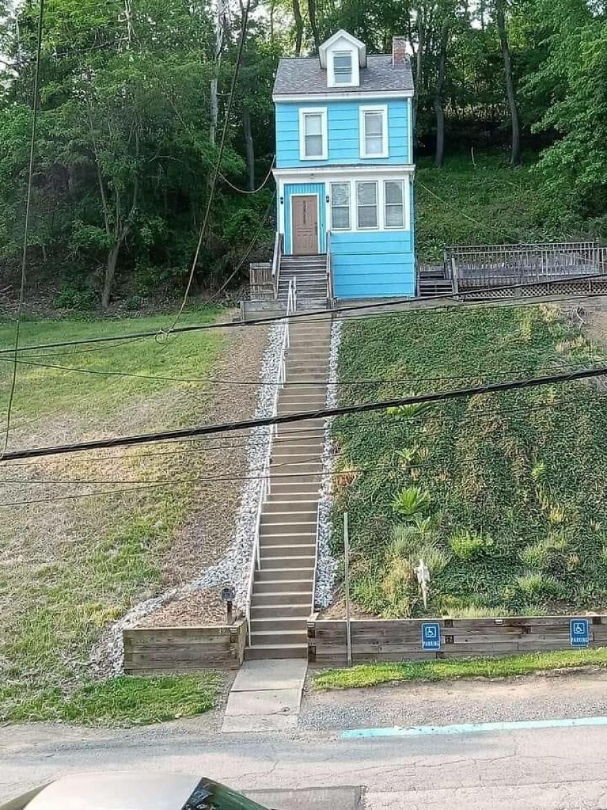 Bright blue house with steep staircase; example of architecture shaming.