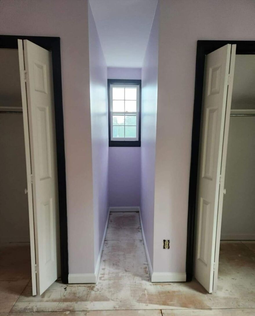 Narrow architectural hallway with two closets and a small window, showcasing awkward design.