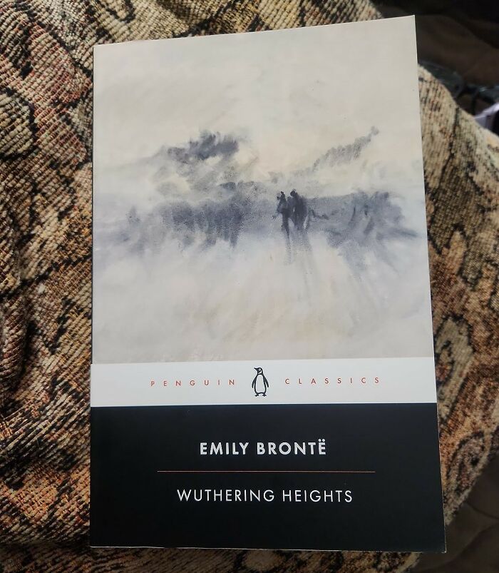 Cover of "Wuthering Heights" by Emily Brontë, a classic romantic book, with a misty landscape painting.