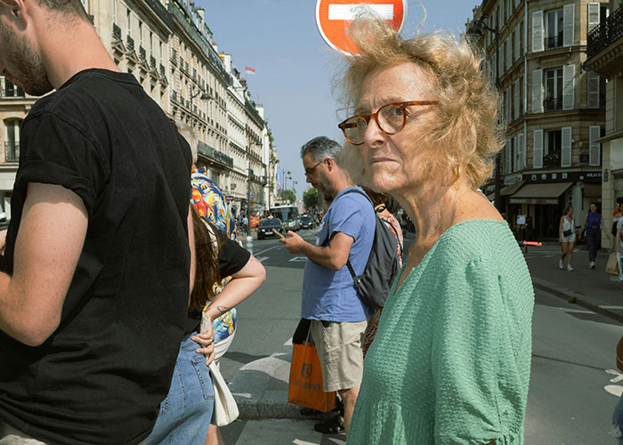 People standing at a street corner in Europe during the day, highlighting culture shocks for Americans.