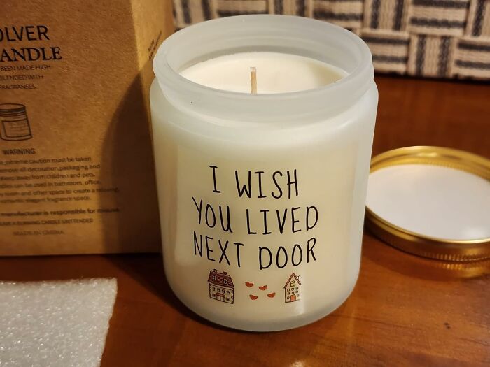 Decorative candle with "I wish you lived next door" text, ideal Galentine's Day gift for a special friend.