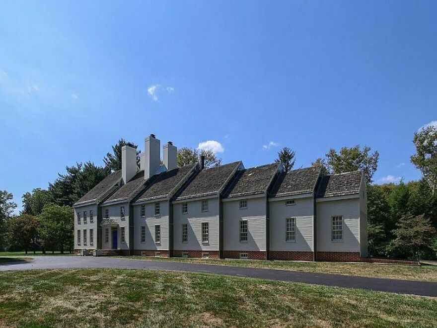 A long, awkwardly designed house with mismatched windows, criticized for bad architecture.