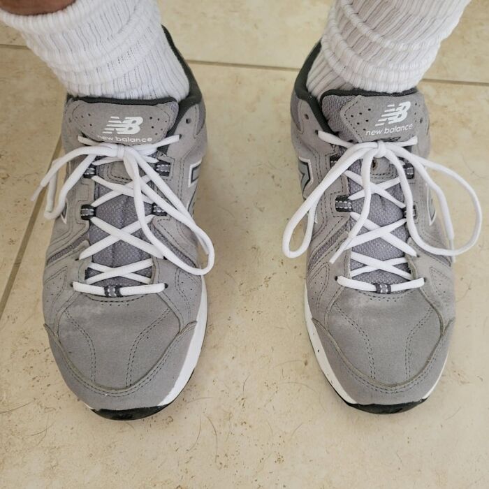 Gray New Balance sneakers on tiled floor, highlighting things worth spending money on.