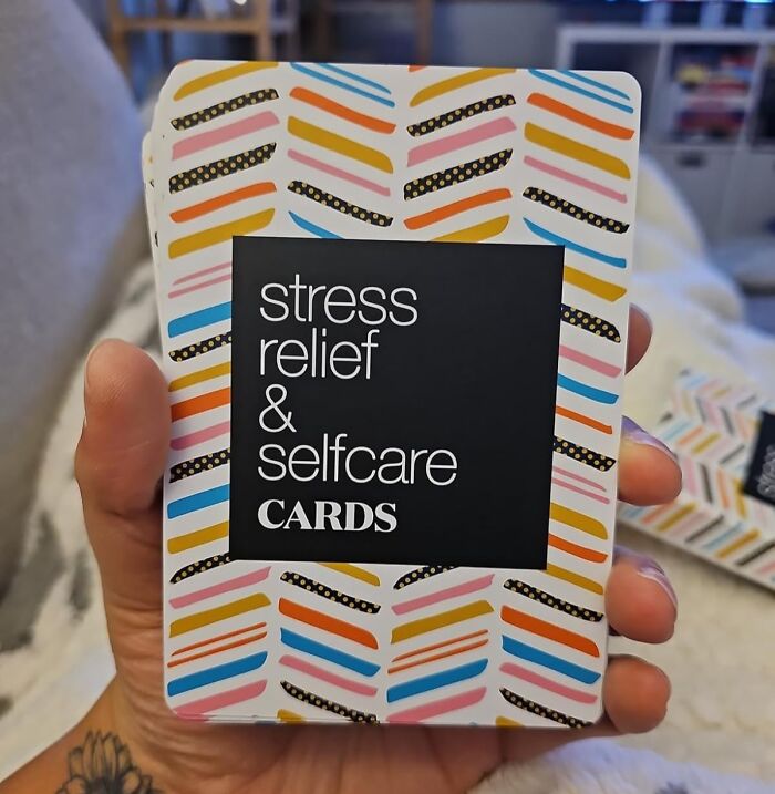 Colorful stress relief and selfcare cards held in hand; a perfect Galentines Day gift idea.