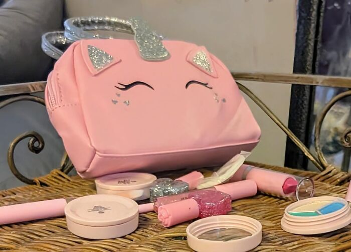 Unicorn-themed makeup set for kids, featuring pink bag and cosmetic items as perfect Valentine's Day gifts.