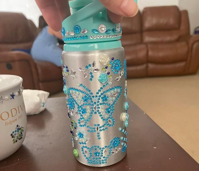 Decorated water bottle with butterfly and floral designs, ideal Valentine's Day gift for kids.