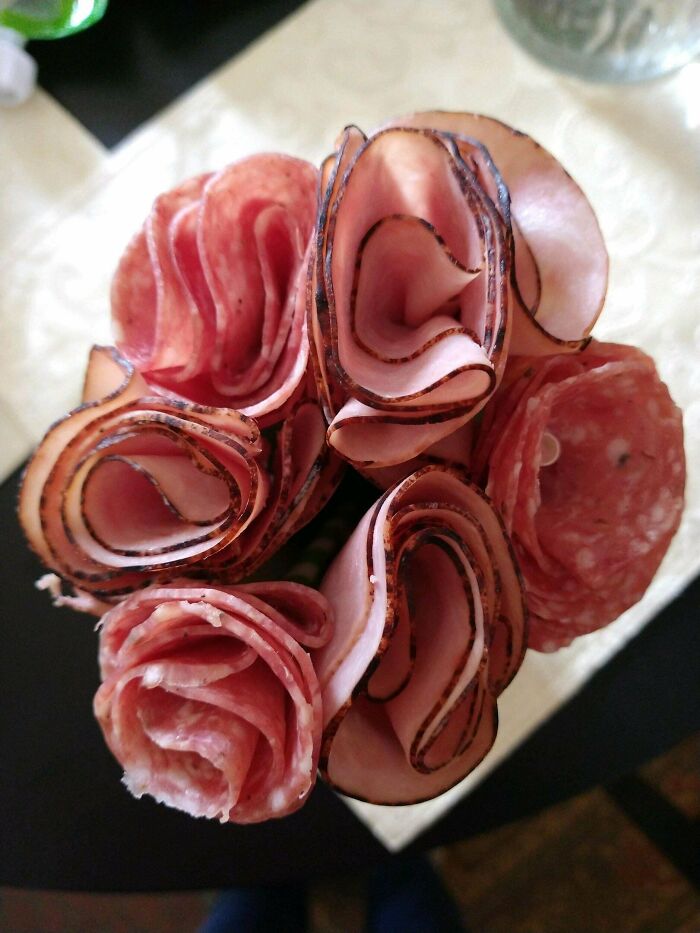 Valentine’s Day gift idea: a bouquet of salami and other cured meats arranged like roses on a table.