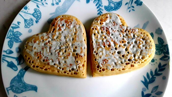 Heart-shaped pancakes with icing on a decorative plate, ideal inspiration for cute Valentine’s Day gifts.