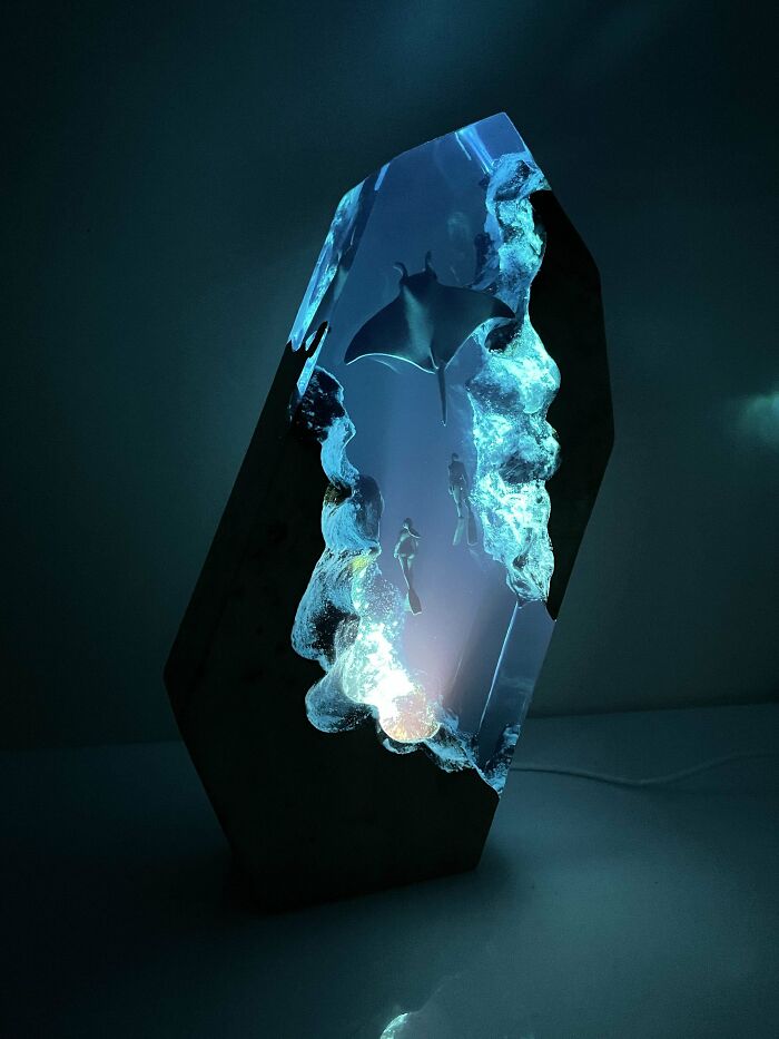 Illuminated sculpture with aquatic scene, featuring a ray and divers. Perfect Valentine's Day gift inspiration.