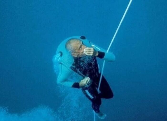 Diver using an underwater sled for descent, showcasing an interesting fact about deep-sea exploration.