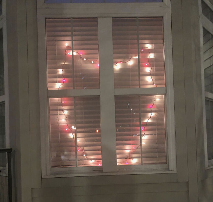 Heart-shaped Valentine lights in a window, creating a cute ambiance for gift inspiration.