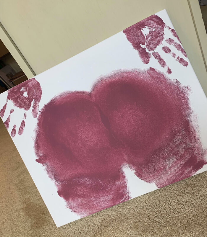 Cute Valentine's art with red handprints, perfect gift inspiration.