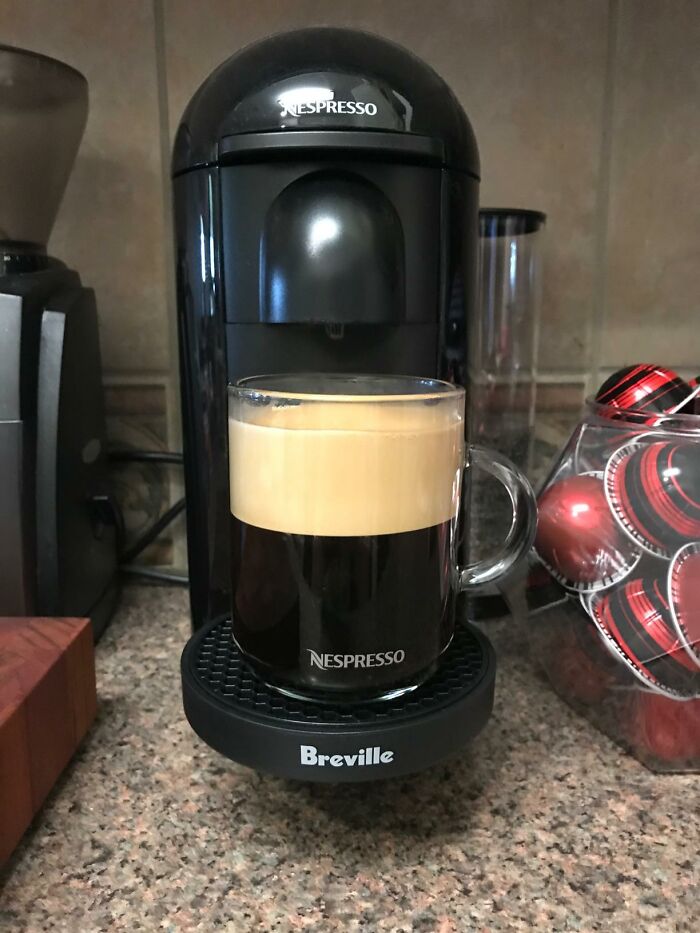 Nespresso coffee machine with a freshly brewed cup, highlighting premium spending items.