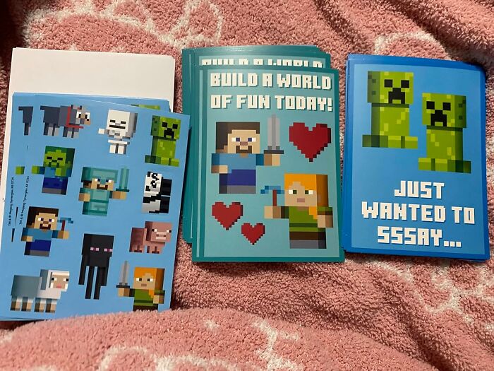 Minecraft-themed Valentine's Day cards for kids on a pink blanket.