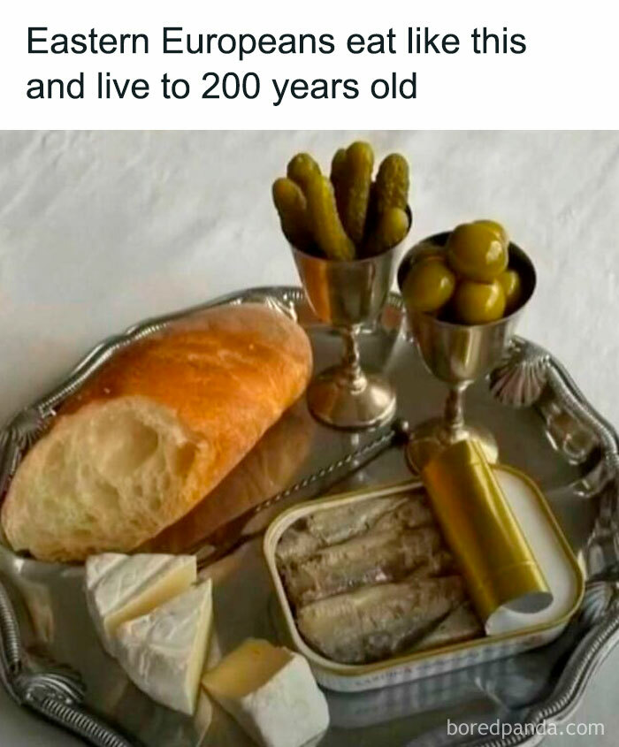 A humorous cooking meme featuring bread, cheese, pickles, olives, and sardines on a tray.