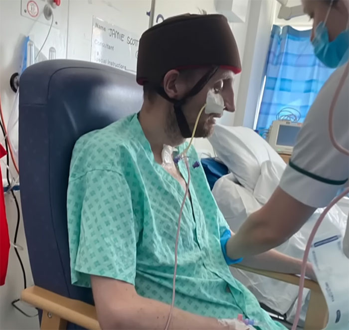 Patient in hospital gown with medical equipment, related to Covid vaccines and potential new syndrome discussion.