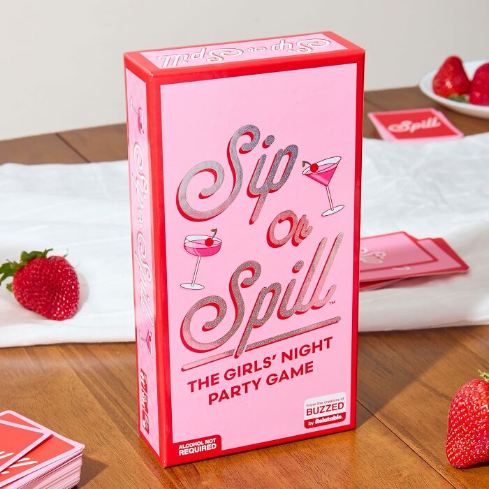 Galentines Day gift idea: "Sip or Spill" party game on a table with strawberries.